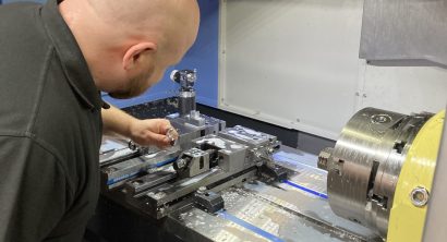 Operator adjusting the interior of a DNM 5700 vertical machining centre