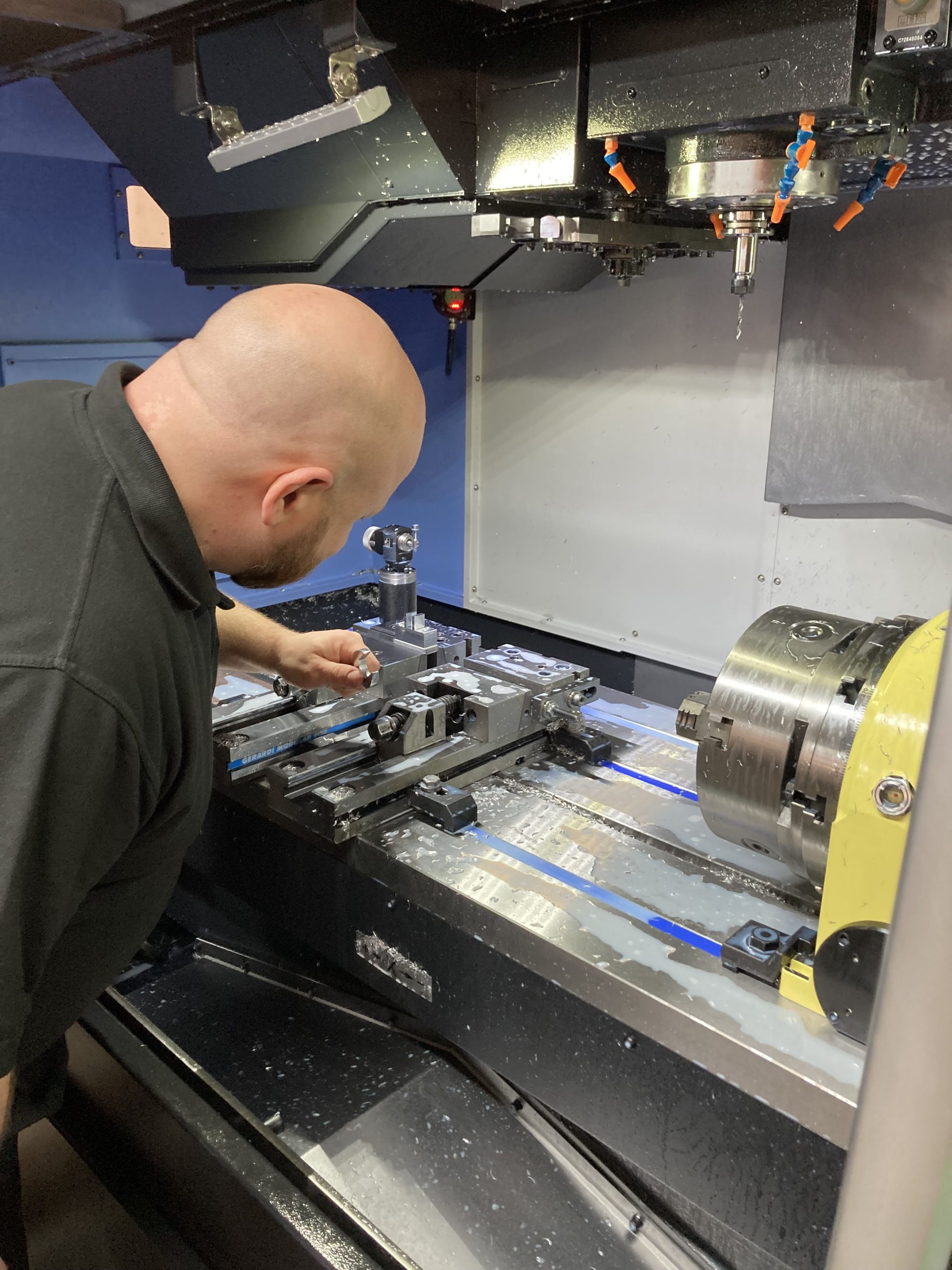 Operator adjusting the interior of a DNM 5700 vertical machining centre